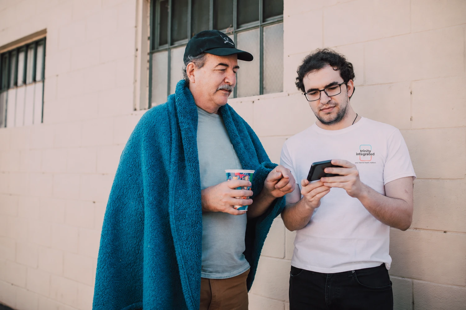 Two people reviewing information together on a device