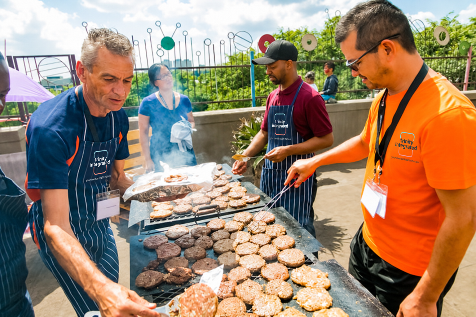 Volunteers cooking food together at a community gathering
