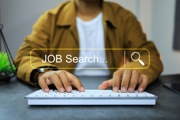 An adult searching for work on a computer